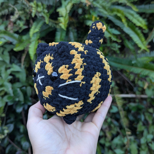 A tortoiseshell crocheted cat