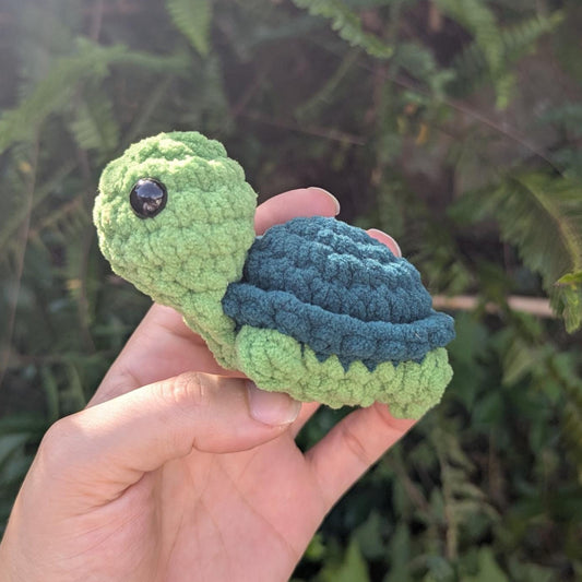 Green plush crocheted turtle with light green body and dark green shell