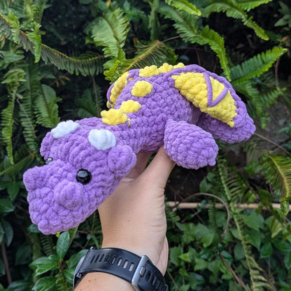 Purple crocheted dragon facing the camera